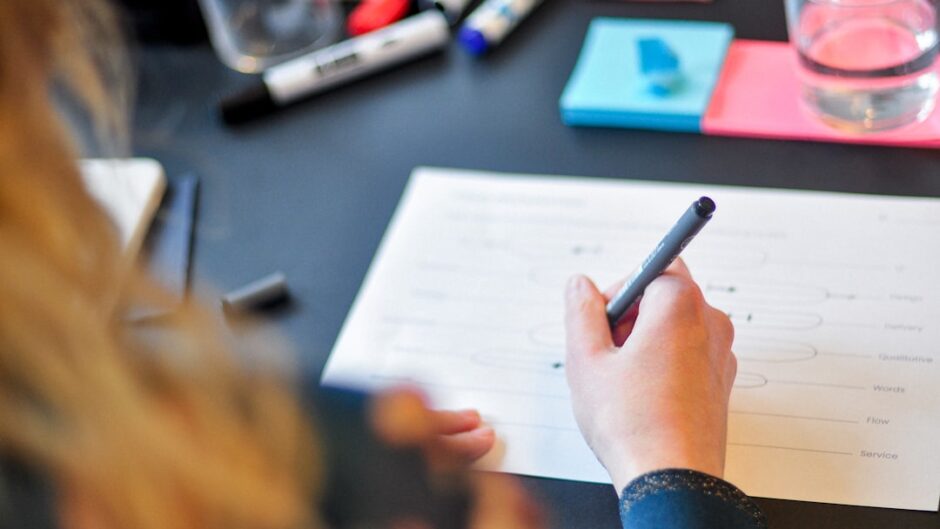 a person writing on a piece of paper